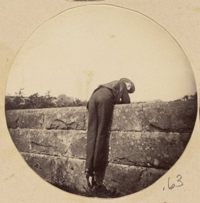 Man in Hat Bent Over a Stone Wall by Unbekannt Unbekannt